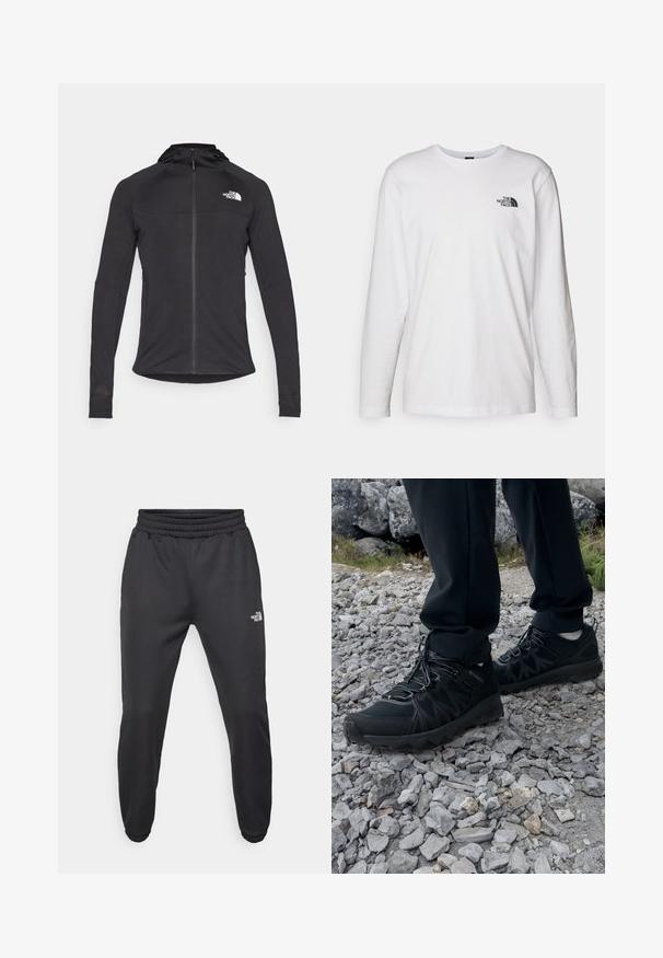 Sort atletisk jakke med lange ærmer, lynlås foran, logo øverst til venstre og hætte. Tekstureret stof med en tætsiddende pasform.; Hvid langærmet T-shirt lavet af bomuld med rund hals. Har et lille sort logo på brystet. Glat tekstur, almindelig pasform.; Sorte sweatpants med snor i livet, tætsiddende pasform, elastiske manchetter og et lille hvidt logo på venstre lår, lavet af glat stof.; Sorte udendørssko med mesh og syntetisk materiale, med en tekstureret overdel, sikre snørebånd og en robust ydersål, på klippelandskab.