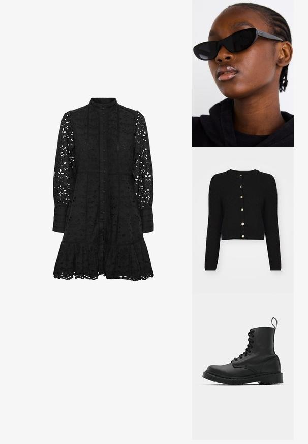 Schwarze, gestrickte, kürzere Strickjacke mit langen Ärmeln, rundem Ausschnitt und sechs dekorativen goldenen Knöpfen entlang der Vorderseite.; Schwarzes besticktes Kleid mit hohem Kragen, Knopfverschluss, langen Ärmeln und gerüschtem Saum. Es weist ausgeschnittene florale und geometrische Muster auf.; Schwarzer Lederkampfstiefel mit runder Zehenpartie, Schnürung vorne und einer Zuglasche am Knöchel. Verfügt über eine dicke Gummisohle für Langlebigkeit.; Schwarze Cat-Eye-Sonnenbrillen mit matter Oberfläche, die sich durch ein elegantes Design und sanft geschwungene Kanten auszeichnen, vor einem Modell in dunkler Kleidung.