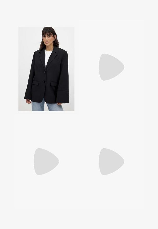 Woman wearing oversized black blazer with wide sleeves over white top and light blue jeans, standing against plain background.; Black, long-sleeve blouse made of lightweight fabric, featuring a V-neck, gathered waist, and layered ruffles at the hem.; Black miniskirt made of smooth, stretch fabric; features a straight cut with a subtle hem and no visible fasteners or patterns.; Tan suede knee-high boot with a block heel, featuring a pointed toe and smooth texture. Minimalistic design with no embellishments.; Black woven shoulder bag with a smooth leather strap and zipper closure. Features a textured surface and curved shape.