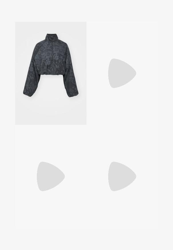 Cropped black jacket with long sleeves, featuring a textured floral pattern and high collar. Includes a front zipper and elasticated hem.; Two sleeveless tops in black and white, made of ribbed cotton, featuring round necklines and a fitted design. Labels visible on both.; Black athletic shorts with a ribbed texture, elastic waistband, curved hems, and a small white Nike logo on the lower side.; Black leather boots with yellow stitching, featuring a chunky rubber sole and metal eyelets, worn on a pink, industrial pipe structure.