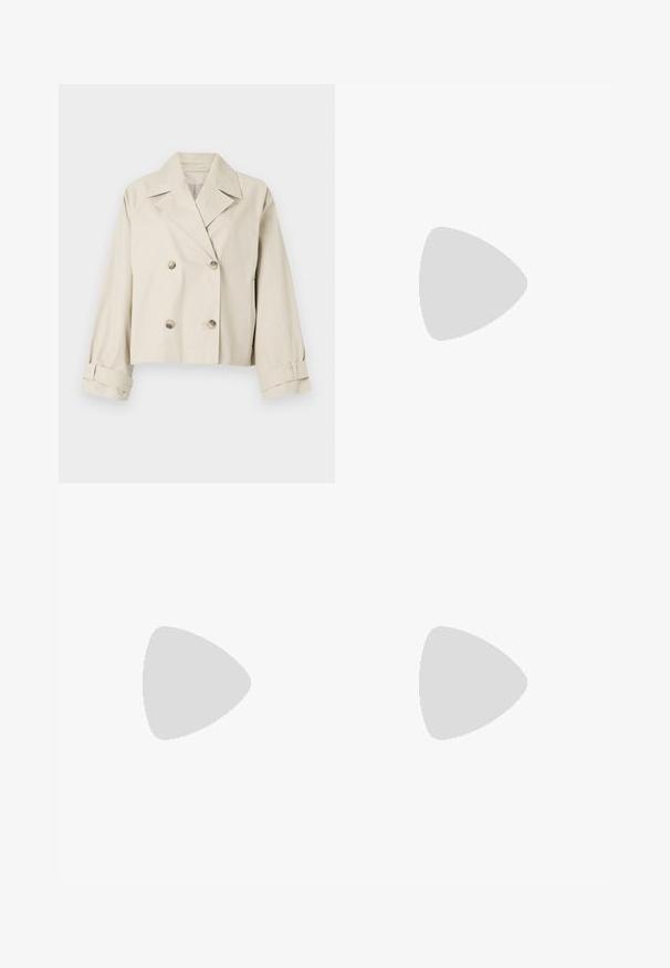 Beige cropped jacket with a double-breasted design, large lapels, and button accents. Features rolled cuffs and a smooth texture.; White ribbed tank top with a round neckline and wide shoulder straps, featuring a soft texture and a fitted silhouette.; Dark brown wide-leg trousers with a high waist, featuring neatly pressed creases, smooth texture, and a tailored fit.; Knee-high black leather boots with a squared toe and block heel, shown with a model seated in an olive green coat. Smooth texture, minimal detailing.