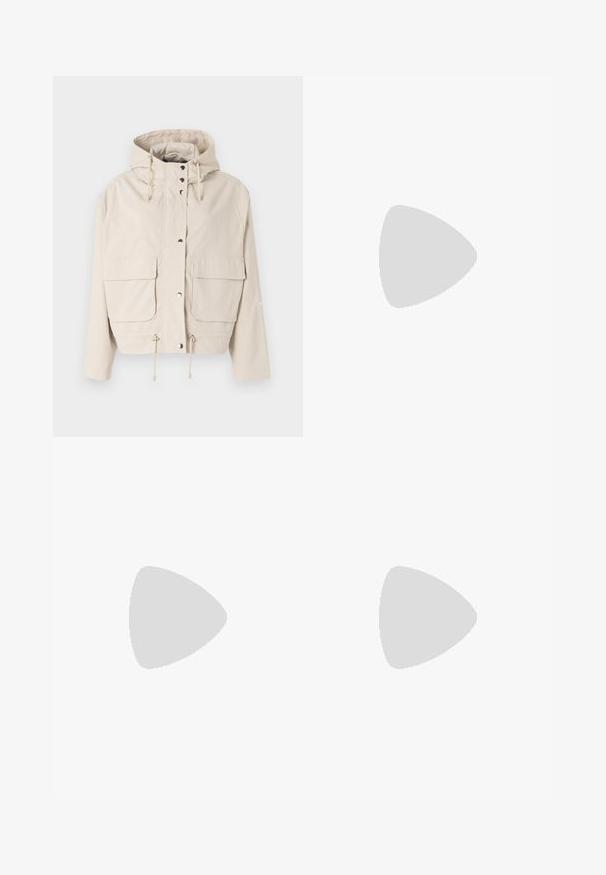 Beige windbreaker jacket with a hood, featuring snap buttons, two front pockets, drawstring at the hem, and a smooth, matte texture.; Dark green sweatshirt made of smooth cotton blend. Features a crew neckline and ribbed cuffs. Cropped design with minimal stitching detail.; Light blue denim shorts with a loose fit, mid-rise waist, and visible stitching. Features side and back pockets, and a button closure.; White leather sneaker with perforated toe box, textured sole, and white laces, paired with wide red pants and a blue and yellow background.