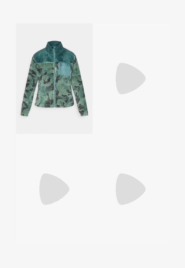Green camouflage zip-up jacket with a high collar, made of textured fabric. Features a contrasting teal pocket and design accents.; Black cropped t-shirt made of cotton, featuring short sleeves, a round neckline, and raw edges for a relaxed look.; Gray wide-leg denim pants with an elastic waistband, drawstring closure, and side pockets. Faded texture throughout the fabric.; Black and white suede sneakers with flat white laces, textured rubber soles, and side stripe design. Worn with cream-colored tapered pants.