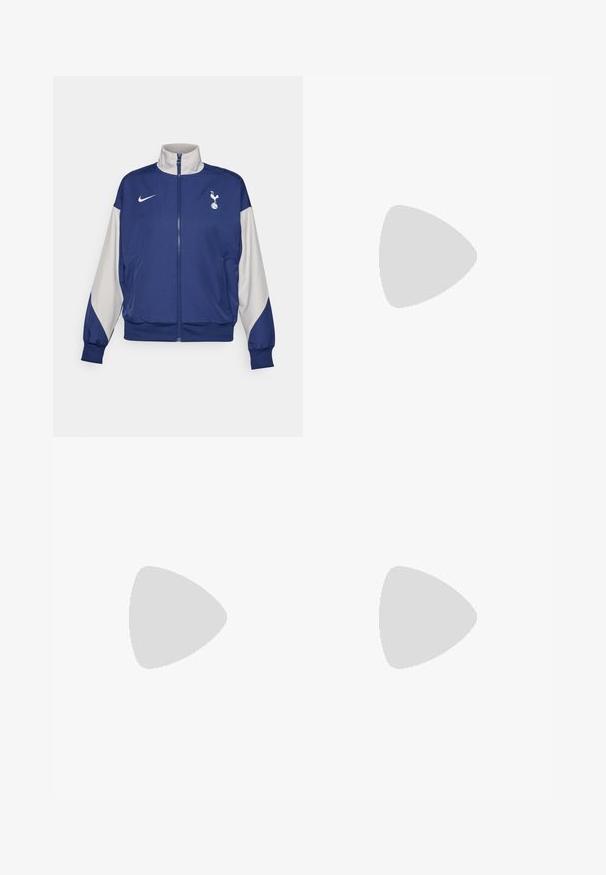 Mörkblå zip-up-jacka med grå ärmar, försedd med hög krage, Nike-logotyp och Tottenham Hotspur-emblem. Tillverkad av mjukt tyg.; Svart atletisk crop top med dragkedja framtill, nätdetaljer och en figurnära design. Tillverkad av elastiskt, andningsbart material. Nike-logga på framsidan.; Nike svarta capri tights har en hög midja, slät stretchfabric och subtil logotypdetalj på framsidan.; Blå och svarta sneakers med mesh-överdela, gradientdesign och rund dämpning i sulan. Bärs med vita ribbade strumpor.