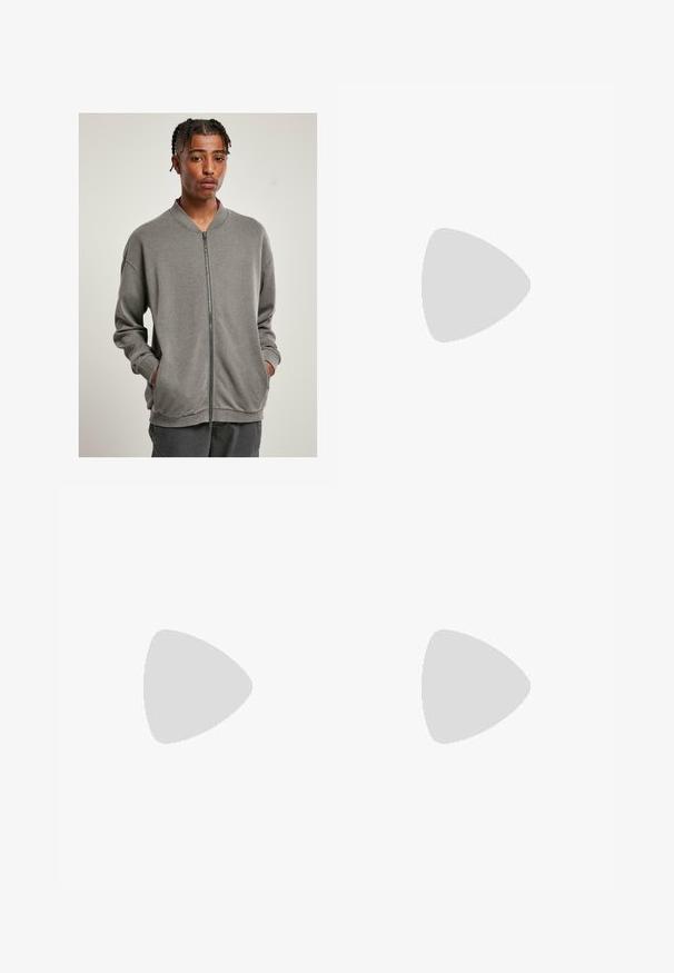 Grå zip-upp sweatshirt med ribbad krage, långa ärmar och sidofickor, tillverkad av mjukt tyg med en slät yta.; Vit bomull t-shirt med korta ärmar, rundad halsringning, avslappnad passform och utan synliga logotyper eller mönster. Slät textur och minimal design.; Ljusblå denim cargo-byxor med en avslappnad passform, med sidofästen och framfickor, som visar en urtvättad textur.; Svarta läderloafers med en sleek design, rund tå, stuckna detaljer och en låg klack. Slät yta och minimala accenter.