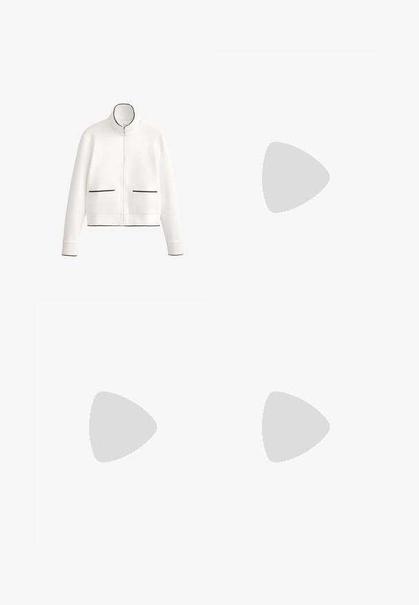 Fehér cipzáras dzseki magas gallérral, fekete díszítéssel és két elülső zsebbel, fekete paszpolozással. Puha, sima anyagból készült.; Fekete bordázott ujjatlan felső, kerek nyakú és széles karöltőkkel. Az anyag lágy hatásúnak tűnik, és testhezálló fazonú.; Fekete nadrág, széles szárakkal, magas derékkal és oldalsó hasítékokkal a könnyű mozgás érdekében. Simító, rugalmas anyagból készült.; Barna velúr sportcipő bézs részletekkel, három bézs csíkkal és textúrált gumitalppal. A fűző sötétbarna.