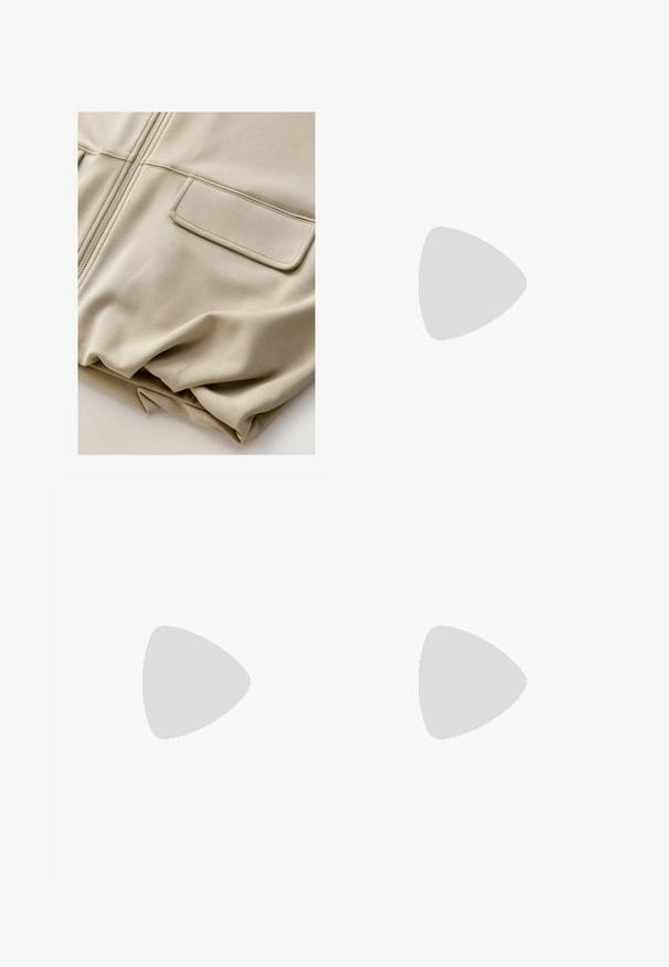 Beige zip-zap jakna z gladko teksturo, dvema sprednjima žepoma in subtilnimi šivi, ki se ponaša s sproščenim krojem in lahkim materialom.; Dva brezrokavniki z rebrasto turtleneck gorami v črni in beli barvi, z oblikovanim dizajnom in gladko teksturo, v skrajšani dolžini.; Črne široke hlače iz lahkega materiala, z zapiranjem na gumb spredaj in ravnim sprednjim delom, s skrbno zašiti robovi.; Športni čevlji z belim usnjenim zgornjim delom, sivim semišem na prstih in tremi črnimi črtami. Imajo modro logo na jeziku in teksturiran gumijast podplat.
