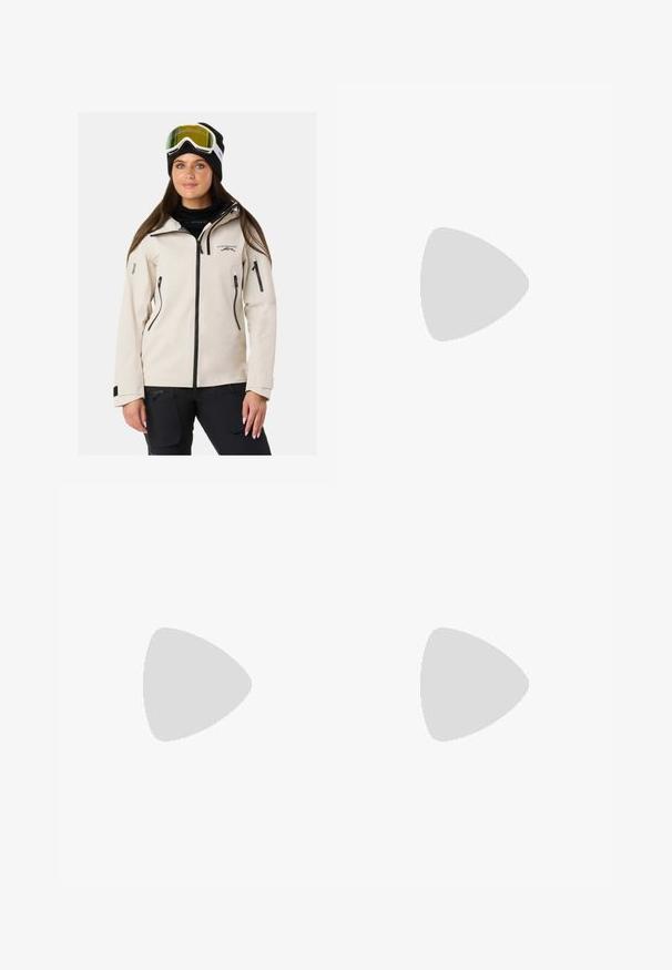 Beige waterproof jacket with black zippers and accents, featuring a zip-up front, side pockets, and a hood. Worn with ski goggles and a beanie.; White long-sleeve top with a wide neckline, side slits, and a smooth, lightweight fabric, featuring a simple, minimalistic design.; Black denim jeans with a straight leg design. Features copper rivets and pockets. Smooth texture and slightly faded finish.; Brown suede sneakers with white accents and laces. Rubber gum sole. Worn with white socks featuring black stripes. Green textured flooring.; Brown suede handbag with long fringe details, a curved shape, and a single shoulder strap. Features a smooth, textured surface.