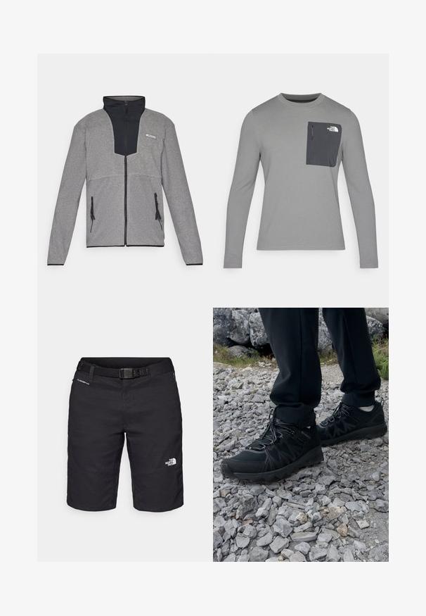 Szary kurtka z czarnym kołnierzem i zamkiem z przodu. Charakteryzuje się kontrastującymi ciemnoszarymi i jasnoszarymi sekcjami, zamkami błyskawicznymi na kieszeniach oraz miękką teksturą.; Szara koszula z długim rękawem o teksturowanej tkaninie, z ciemnoszarym kieszonką na piersi i zapięciem na zamek. Logo na kieszeni w kolorze białym.; Czarne szorty hikingowe wykonane z lekkiego materiału, z paskiem, detalami w postaci szwów oraz logo na prawej nodze.; Czarne buty outdoorowe wykonane z siateczki i materiału syntetycznego, z fakturowaną cholewką, zabezpieczonym systemem sznurowania i solidną podeszwą, na skalistym terenie.
