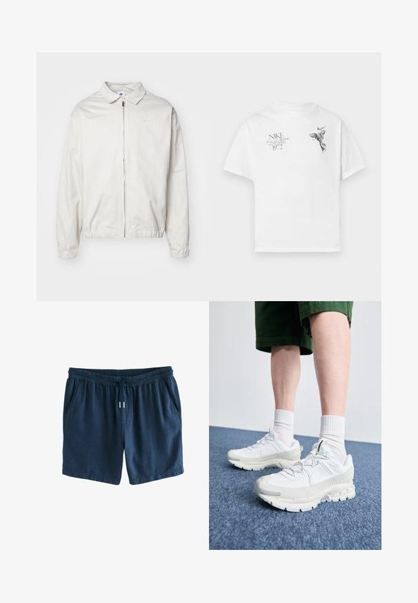 Giacca Nike bianca, leggera, con colletto, zip frontale, polsini elasticizzati e un piccolo logo sul lato sinistro del petto. Texture liscia.; T-shirt in cotone bianco con stampa grafica nera di una figura alata e testo, con collo tondo e maniche corte.; Pantaloni short blu navy realizzati in un tessuto leggero. Presentano una vita elastica con coulisse e due tasche laterali. Design semplice.; Scarpe da ginnastica bianche con sovrapposizioni testurizzate, suola spessa e accenti grigi. Indossate con calze corte bianche e pantaloni corti verdi su una superficie blu.