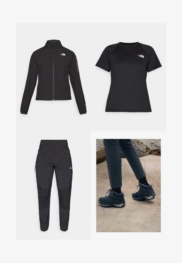 Črna zip-up jakna z visokim ovratnikom, teksturirano blago in logotipom na levem prsnem delu. Ima dolge rokave in prilega se.; Črna kratka športna majica s kratkimi rokavi in krožnim izrezom, z logotipom The North Face na zgornjem levem prsnem delu.; Črne zunanje hlače iz trpežnega materiala. Imajo žepke na zadrgo, ojačane kolenske dele in ravno krojeno zasnovo za prosto gibanje.; Temno modri pohodni čevlji z teksturirano mrežo, vezalkami in gumijastimi podplati, v kombinaciji s temnimi hlačami, na peščeni in skalnati podlagi.