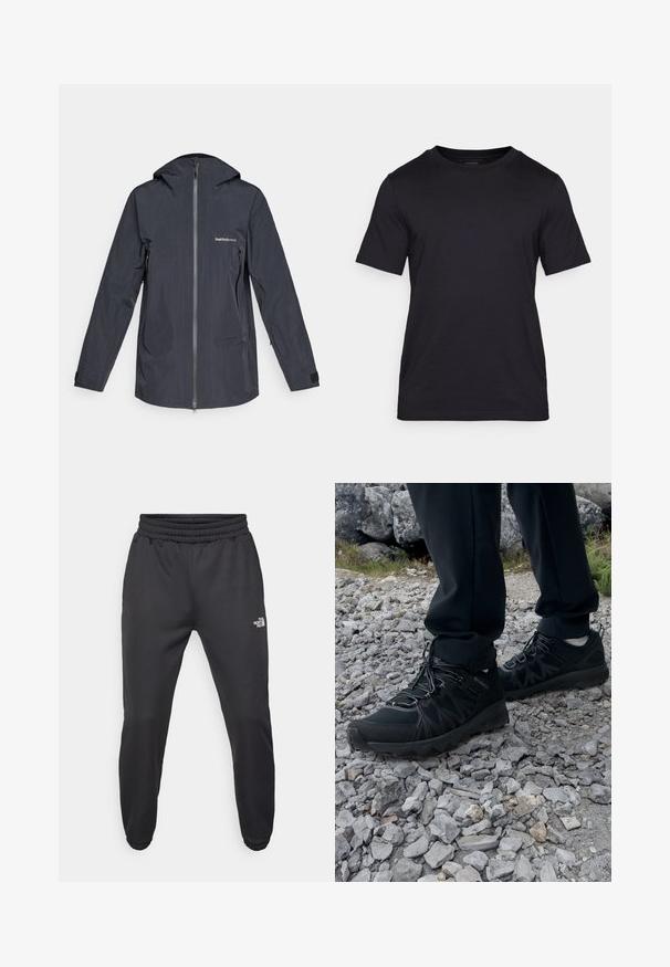 Veste à capuche imperméable gris foncé avec fermeture éclair à l'avant, poches latérales zippées et logo "Peak Performance" sur la poitrine.; T-shirt noir en tissu lisse, avec un col rond et des manches courtes. Marque subtile imprimée en noir sur la poitrine.; Pantalons de survêtement noirs avec une taille à cordon de serrage, coupe fuselée, poignets élastiques et un petit logo blanc sur la cuisse gauche, fabriqués en tissu lisse.; Chaussures d'extérieur noires en matériau synthétique et en maille, présentant une tige texturée, un système de lacets sécurisé et une semelle extérieure robuste, sur un terrain rocailleux.