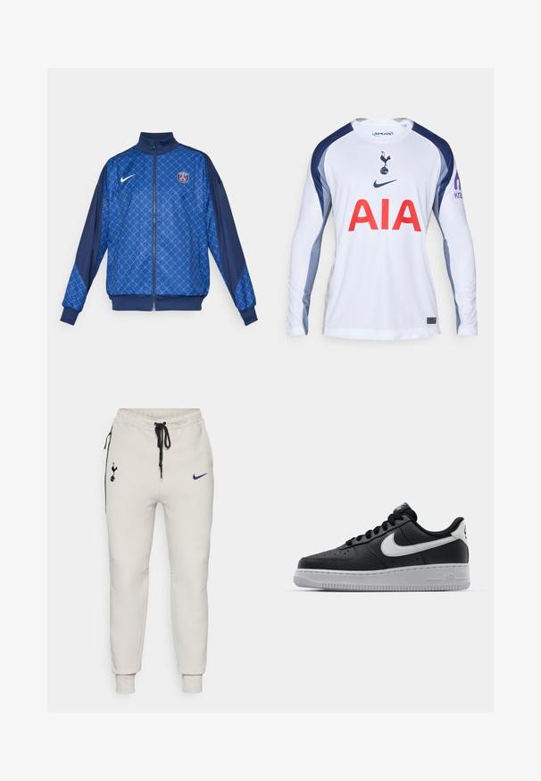 Blå zip-up jakke med geometrisk mønster, der har høj krave og elastiske manchetter. Nike-logo på fronten sammen med et Paris-tema badge.; Hvid langærmet fodboldtrøje med marineblå detaljer, der har Tottenham Hotspur-logoet og "AIA" i rødt hen over fronten.; Lys grå Nike joggingbukser med sorte detaljer. Har broderede logoer, elastisk talje med snor og manchetter ved anklerne.; Sort lædersneaker med tekstureret overflade, hvid Nike swoosh, grå sål, rund tå og snørebåndsdesign. Har perforeringer på tåboksen.