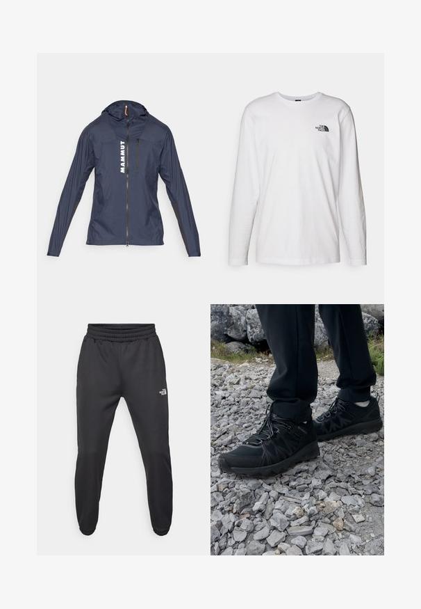 Mørkeblå letvægtsjakke med lynlås foran og hætte, med hvid "MAMMUT" tekst og sorte detaljer på ærmerne og siderne.; Hvid langærmet T-shirt lavet af bomuld med rund hals. Har et lille sort logo på brystet. Glat tekstur, almindelig pasform.; Sorte sweatpants med snor i livet, tætsiddende pasform, elastiske manchetter og et lille hvidt logo på venstre lår, lavet af glat stof.; Sorte udendørssko med mesh og syntetisk materiale, med en tekstureret overdel, sikre snørebånd og en robust ydersål, på klippelandskab.