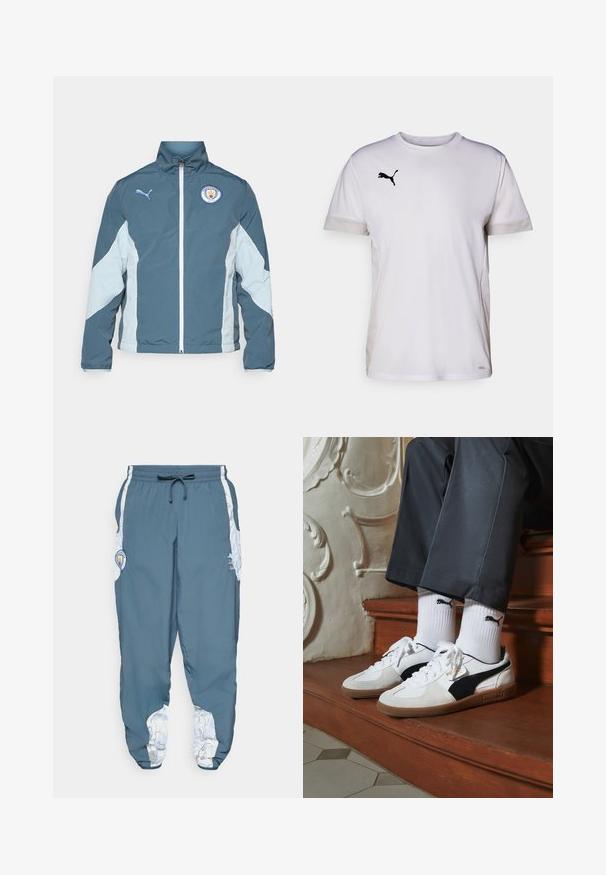 Casaco corta-vento em verde-escuro e azul-claro, com fecho éclair na frente, gola alta e logotipo do Manchester City no peito.; Camisola atlética branca de manga curta com decote redondo, apresentando detalhes em malha respirável nas laterais e um logo da Puma em preto no peito.; Calças de treino em tecido azul com cintura elástica e cordão. Os detalhes laterais apresentam um padrão branco. Inclui um patch com o logótipo da marca.; Ténis Puma em camurça branca e preta, com uma sola de borracha castanha. Combinados com meias brancas exibindo um logótipo preto, usados com calças escuras.