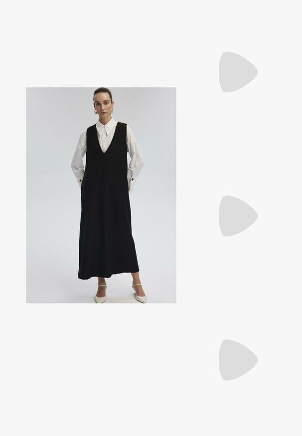 Femme portant une longue robe sans manches noire sur une chemise blanche avec de larges poignets et des boutons dorés, associée à des escarpins blancs pointus.; Body noir à manches longues avec décolleté carré et fermetures à pression à l'entrejambe, posé à plat sur un fond blanc.; Baskets en suède bordeaux avec trois bandes blanches et accents beige. Elles possèdent une semelle en caoutchouc texturé et un logo doré sur le côté.; Sac fourre-tout noir texturé avec poignées courtes, présentant un fermoir et des accents dorés. Le design est structuré, avec une silhouette géométrique.