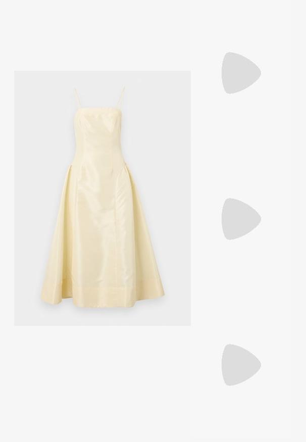 Um vestido de cetim amarelo com um corpete ajustado, alças finas e uma saia volumosa, apresentando uma textura suave e um leve brilho.; Saltos altos pretos com bico fino e atilho ajustável no tornozelo. Confeccionados em couro suave, apresentam um salto bloco robusto.; Bolsa de couro preta com forma curva, alça destacável e detalhes em dourado. A bolsa possui uma aba com detalhe de fivela.; Brincos em tom de ouro com formas onduladas e texturizadas. Inclui studs escultóricos com presilha e um design de argola aberta com um acabamento martelado.