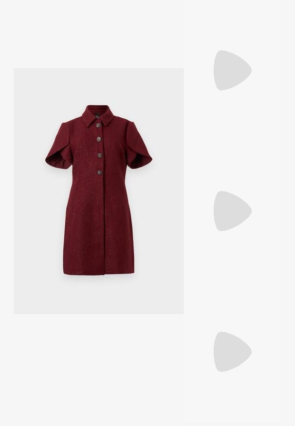 Burgundy short-sleeve coat dress with pointed collar and four decorative silver buttons down the front.; White leather sneakers with a thick white sole, black suede heel accent, and embossed logo on the side. Laced design with six eyelets.; Black oversized sunglasses with a geometric shape, featuring dark lenses and a contrasting grey detail on the frame. Logo on the arm.; Silver hoop earrings with a smooth, shiny finish. Rounded shape, lightweight design, featuring a post-back closure.