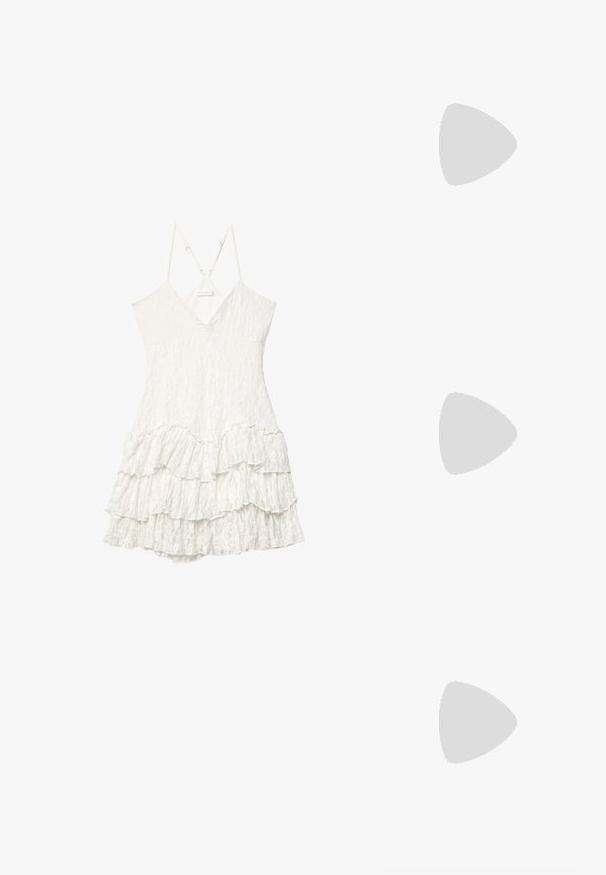 Biała koronkowa sukienka bez rękawów z dekoltem w kształcie V, regulowanymi cienkimi ramiączkami i warstwowym wykończeniem w falbanach.; Czarne lakierowane botki za kostkę z wysmukłym noskiem i średniej wysokości obcasem w kształcie słupka. Gładka tekstura i minimalistyczny design.; Brązowe gradientowe okulary przeciwsłoneczne z dużymi okrągłymi soczewkami, błyszczącymi oprawkami w wzór żółwia oraz smukłymi zausznikami z delikatnymi metalicznymi akcentami.; Czarna torebka o usztywnionym kształcie, gładkiej fakturze i metalowym zapięciem. Połączona z szerokimi czarnymi spodniami i sandałami na otwartym palcu na drewnianej podłodze.