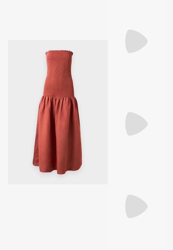 Long, strapless dress with a smocked bodice in a rust color, featuring a flared, gathered skirt for a textured look.; White leather sneakers, low-top design, featuring a smooth texture, round toe, laced front, and a small embroidered logo on the side.; Black leather half-moon bag with a gold hardware accent, featuring a zip closure. Worn crossbody over a gray sweater.; Gold-tone knot stud earrings with a twisted design. Each earring features a circular clear backing for secure wear.