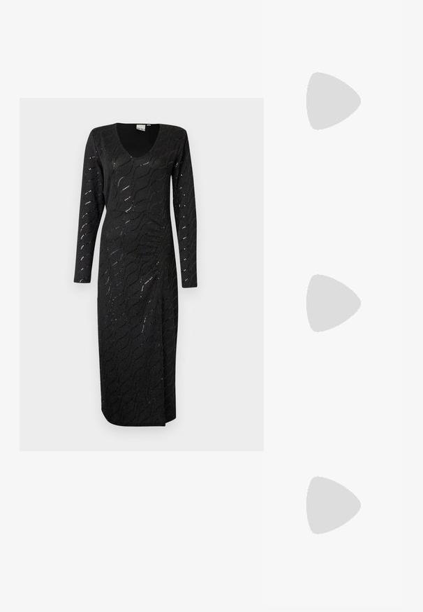 Fekete, hosszú ujjú, V nyakú ruha, amely texturált hullám mintával és finom csillogással rendelkezik. Ankle hosszúságú, oldalsó hasítékkal a szabad mozgás érdekében.; Fekete lakk bőr, pántos magassarkú cipő, hegyes orral, lekerekített kivágással és tömbsarkal. Arany színű csat díszíti.; Fekete, oversize napszemüveg fokozatos árnyalatú lencsékkel, vastag kerettel és arany színű lánc díszítéssel a szárakon.; Fekete kézi táska strukturált formával, sima textúrával és fémből készült záródással. Széles fekete nadrággal és nyitott orrú szandállal párosítva, fából készült padlón.