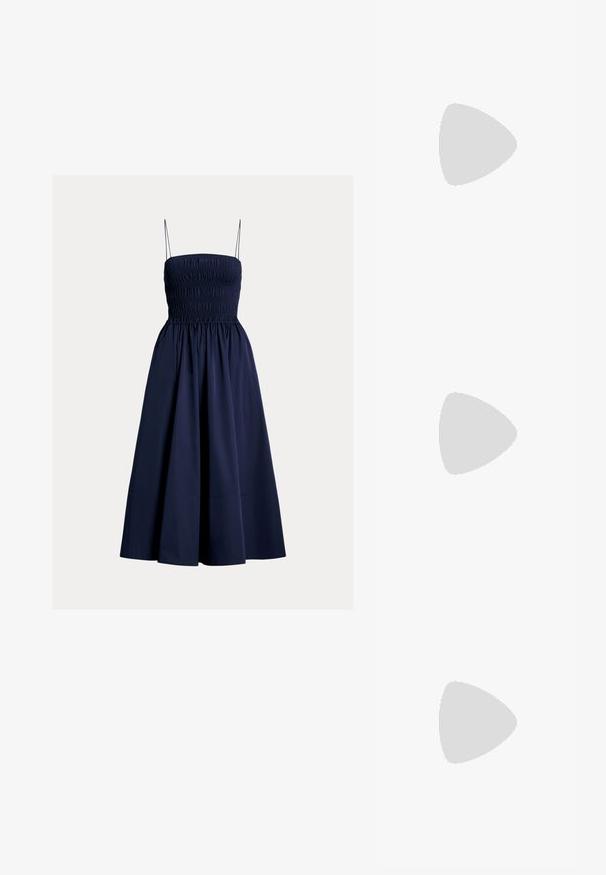 Polo Ralph Lauren DAY DRESS - Day dress - cruise navy; White leather sneakers, low-top design, featuring a smooth texture, round toe, laced front, and a small embroidered logo on the side.; Black leather half-moon bag with a gold hardware accent, featuring a zip closure. Worn crossbody over a gray sweater.; Gold-tone knot stud earrings with a twisted design. Each earring features a circular clear backing for secure wear.