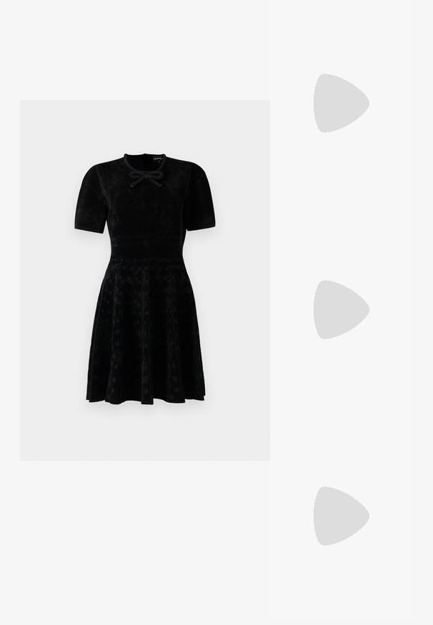 Black short-sleeve velvet dress with fitted waist, flared skirt with subtle polka dots, and a small bow detail at the neckline.; White leather sneakers, low-top design, featuring a smooth texture, round toe, laced front, and a small embroidered logo on the side.; Black leather half-moon bag with a gold hardware accent, featuring a zip closure. Worn crossbody over a gray sweater.; Gold-tone knot stud earrings with a twisted design. Each earring features a circular clear backing for secure wear.