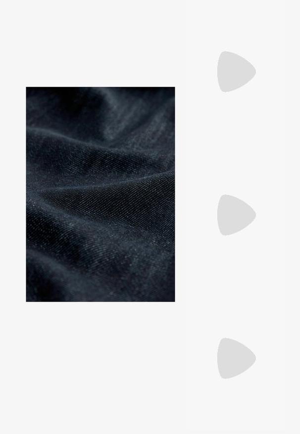 Tamno plavi denimski materijal s suptilnom teksturom, koji ima glatku površinu i blagi sjaj, prikazuje preklopljene i nabore.; Crne kožne pumpe s oštrim vrhom i niskom blok petom. Sadrže remen oko gležnja s zlatnim kopčanjem. Glatka tekstura.; Crne prevelike sunčane naočale s gradijentnim lećama, debelim okvirom i zlatnim lancem kao detaljem na krakovima.; Crna torba s oblikom koji sadrži strukturu, glađu teksturu i metalnu kopču. Uparena s širokim crnim hlačama i sandalama na otvorenom s drvenog poda.