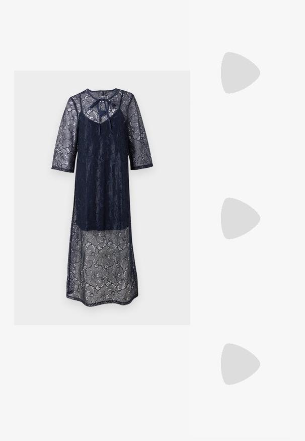 Navy blue lace dress with three-quarter sleeves, featuring a rounded neckline and a tie detail at the front. Sheer lace overlay throughout.; Black patent leather sandal with a low heel, featuring crisscross straps and an adjustable ankle strap. Smooth, shiny surface.; Black leather handbag with a rounded shape, thick handle, and a silver chain strap. Smooth texture with a slight sheen.; Gold-tone hoop earrings with a smooth, polished finish. Features a half-circle shape and a secure post closure.