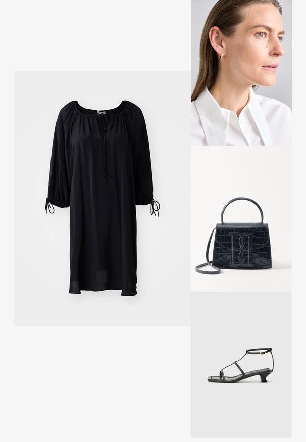 Czarna sukienka do kolan z okrągłym dekoltem, z wiązaniem na sznurki oraz bufiastymi rękawami z wiązaniami przy mankietach. Gładka tekstura materiału.; Czarne skórzane sandały z kwadratowym noskiem, cienkimi paskami, regulowanym paskiem przy kostce i niskim obcasem. Oferują mały złoty akcent na pasku.; Czarna torebka z tłoczonej skóry krokodyla o zorganizowanej konstrukcji, z górnym uchwytem, regulowanym paskiem i wyraźnym detalem z logo z przodu.; Złota kolczyk w kształcie obręczy z małym dekoracyjnym akcentem w postaci gemu. Noszony przez modelkę z prostymi włosami, w zestawie z białą koszulą z kołnierzykiem.