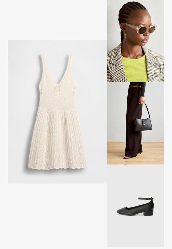 Vestido de malha em creme, com decote em V, corpete canelado e saia evasê com bainha ondulada e padrão de rendilhado por todo o vestido.; Sandal de pele preta com bico pontiagudo e um salto bloco baixo. Apresenta uma tira no tornozelo com uma fivela em tom dourado. Textura suave.; Óculos de sol estilo cat-eye claros com lentes castanhas e armação transparente. Modelo a usar uma blusa verde com nervuras e um blazer de tecido xadrez. Brincos em forma de argola dourados.; Bolsa preta com forma estruturada, textura suave e um fecho metálico. Combinada com calças largas pretas e sandálias de salto aberto sobre um chão de madeira.