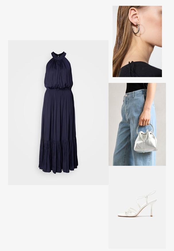 Svetlo modra halter obleka iz mehkih, tekočih materialov, z nabranim zgornjim delom, elastičnim pasom in večplastnim volančkom na robu.; Bela sandala na visoki pet z zavezanimi trakovi, z ravnim podplatom, teksturirano sprednjo stranjo z nabranimi detajli in ozkim gležnjenjem.; Metalna srebrna torba na ramenu z zrnato površino, okrašena s srebrnim okroglim ročajem in zapiranjem na vrvico, držana ob svetlo modrih džinsih.; Srebrna obročasta uhana s polirano površino, ki vključuje majhne zlate poudarke in okroglo obliko, nošena na ušesnem lobu.