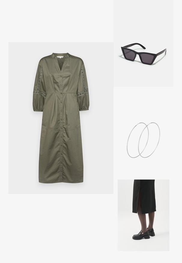 Olivnozeleni srajčni plašč z V-izrezom, nabranimi balonastimi rokavi in čipkastimi detajli ob rokavih. Bombažni material, srednje dolžine.; Črne usnjene čevlje s zaobljenim prstom, debelim blokastim petama in elastičnimi stranskimi detajli, v kombinaciji s temno nogavicami in črno krilo z razporkom.; Črne, angularne sončne očala z sivimi lečami; izdelana iz plastike, imajo debele ročke z gladko površino in brez vidne opreme.; Srebrne uhane v obliki obroča z minimalističnim dizajnom. Krožna oblika, gladka tekstura in tanek profil. Lahki s poliranim zaključkom.