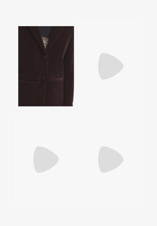 Blazer in corduroy marrone con colletto a revers, due tasche frontali e due bottoni. Il tessuto presenta una texture a coste verticali.; Canottiera light beige in tessuto a costine, con scollatura rotonda e spalline spesse, dalla forma aderente e con dettagli minimi.; Pantaloni beige chiaro, dalla vestibilità ampia, con un elastico in vita e cordoncino. Presentano due tasche laterali e una texture liscia.; Scarpa slip-on in suede marrone con tacco basso, cinturino regolabile con fibbia argentata e suola in gomma nera.