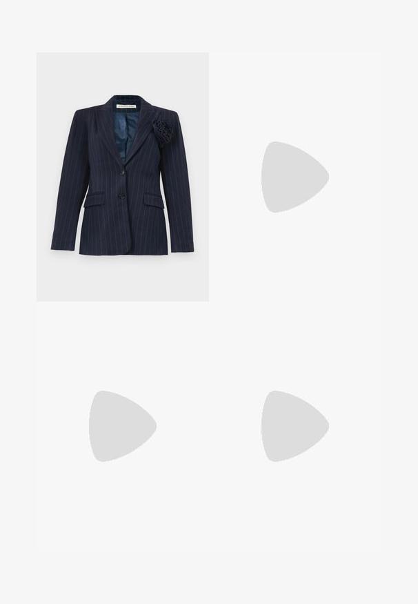 Navy blue pinstripe blazer with two buttons, flap pockets, a notched collar, and a fabric flower pinned on the left lapel.; Navy blue sleeveless top made of smooth, stretchy fabric. Features gathered side detailing and a rounded hem for a fitted look.; High-waisted black trousers made of cotton. Features a wide-leg design, pleats, and rolled cuffs. Smooth texture, no visible patterns or hardware.; White leather high-heeled shoe with a pointed toe, ankle strap, and a slim stiletto heel. Smooth texture with subtle glossy finish.