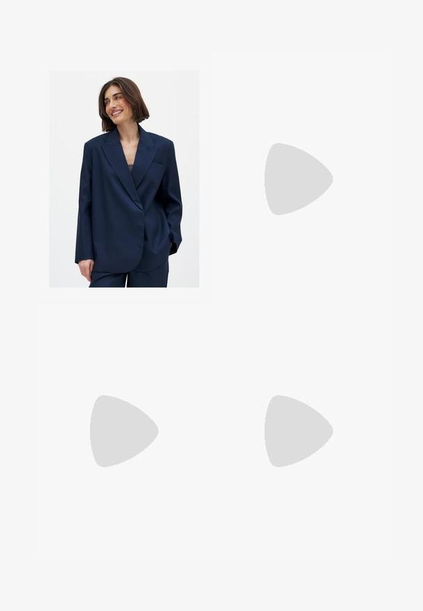 Navy blue blazer in smooth fabric with a notched lapel, single front pocket detail, and slightly oversized fit. Suitable for various occasions.; White ribbed tank top with a round neckline and sleeveless design, featuring a straight hem and a smooth, stretchy texture.; Light blue denim jeans with a straight-leg design, five-pocket style, and visible stitching details. The fabric has a soft, slightly faded texture.; Sport shoes with a white leather upper, gray suede toe, and three black stripes. Features a blue logo on the tongue and a textured rubber sole.