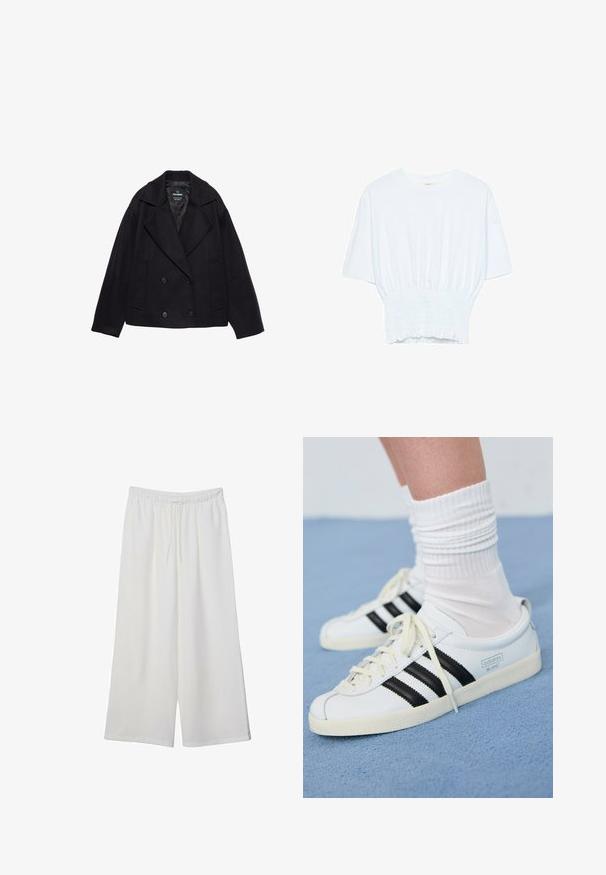 Čierny dvojradový kabát s veľkými klopami, dlhými rukávmi a dvoma prednými vreckami. Vyrobený z textúrovanej vlnenej zmesi.; Biela krátka T-shirt s voľným strihom a zlaceným textúrou v oblasti pása. Vyrobená z mäkkého, ľahkého materiálu.; Biele široké nohavice z ľahkého materiálu s elastickým pásom a šnúrkou na nastavenie veľkosti. Hladká textúra.; Biele kožené tenisky s čiernymi pruhmi, krémovou podrážkou a svetlými šnúrkami. Nosené s bielymi rebrovanými ponožkami, umiestnené na modrom pozadí.