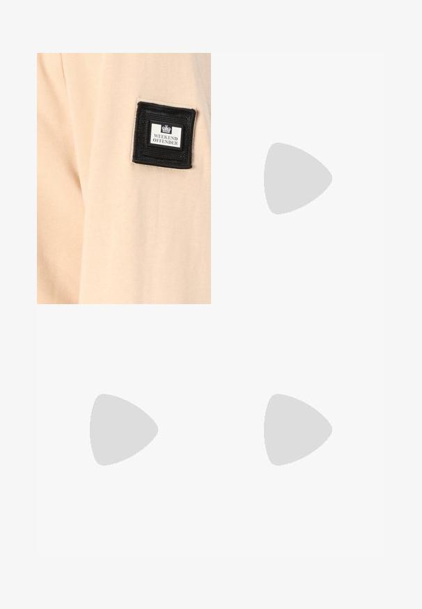 Beige fabric with a soft texture, featuring a black square patch labeled "WEEKEND OFFENDER" with a white logo.; Black denim wide-leg pants with a high waist, featuring five pockets and a button closure. Fabric has a smooth texture and slight stretch.; Black sneakers with a suede and synthetic upper, featuring three white stripes, textured rubber sole, and blue logo tag on the tongue.; Black oval sunglasses with dark lenses, thick frames, and silver dot accents on the sides. Smooth plastic material, contemporary design.
