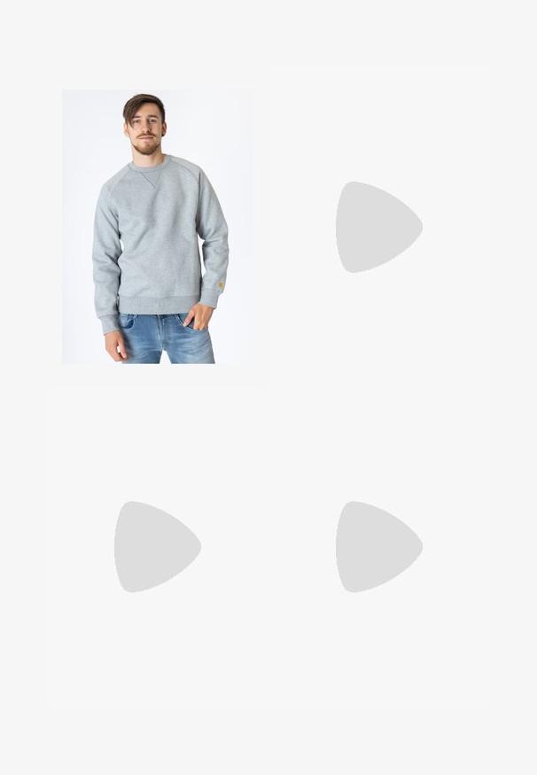 Carhartt WIP CHASE - Mikina - ash heather; Bílé bavlněné tričko s krátkým rukávem a kulatým výstřihem, s malým zlatým logem na levé straně hrudi. Měkká textura a klasický střih.; Tmavě modré džíny s vysokým pasem, rovnými nohavicemi, kontrastním šitím a nášivkami na přední straně.; Černé semišové tenisky s bílými gumovými podrážkami a bočními pruhy, spárované se světle zelenými cargo kalhotami, stojící na texturovaném tmavém povrchu.