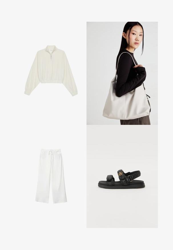 Kort striktrøje i cremefarvet stof med høj krave, halvlynlås, elastisk kant og manchetter, glat tekstur og minimalistisk design.; Hvide bukser med vidde lavet af blødt stof, med bindebånd i taljen og to forlommer. Glat tekstur og uden synlige mønstre.; Sorte quiltede sandaler med to justerbare stropper, guldfarvede detaljer og en tekstureret sort sål. Slankt og moderne design.; Beige håndtaske lavet af blødt materiale med et slouchy design, stikninger og to skulderremme. Velegnet til daglig brug.