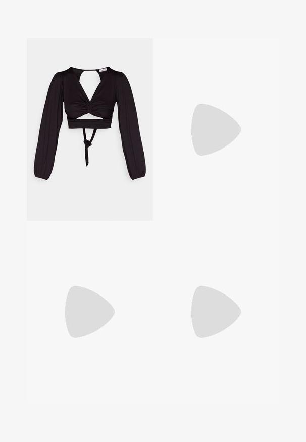 Svart avkortet topp med lange pufferm, vridd frontdesign og åpen rygg. Har et bånd i livet og glatt, elastisk stoff.; Hvite, rette bukser laget av lett stoff med svak tekstur. Har frontlommer og en enkelt press for ekstra detalj.; Høye svarte kanvas-sneakers med hvite øyler, snører og gummisåle. Har en teksturert tåhette og svarte og hvite striper som detaljer.; Olivenfarget kordfløyelsveske med to frontlommer, gullhardware og en kort stropp. Brukt sammen med en lys grønn stripet genser.