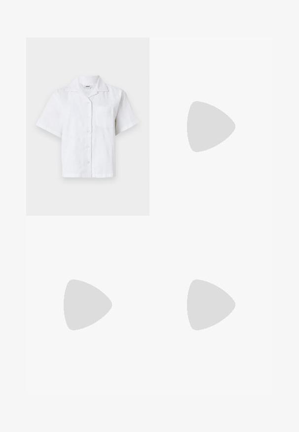 Korte mouwen witte shirt met een textuurpatroon, knoopsluiting en borstzak. Gemaakt van lichtgewicht stof met een relaxte pasvorm.; Multikleurige wijde broek met een geometrisch patroon in roze, groen, oranje en zwart. Gemaakt van lichtgewicht stof met een soepele afwerking.; Lichtblauwe sneakers gedragen met bruine en blauwe geblokte wijde broekspijpen op een lichtblauw tapijt.; Groen getinte zonnebril met een slank, rechthoekig frame en donkere lenzen; gestructureerde grijze armen met branding. Glad huid en een zwart shirt.