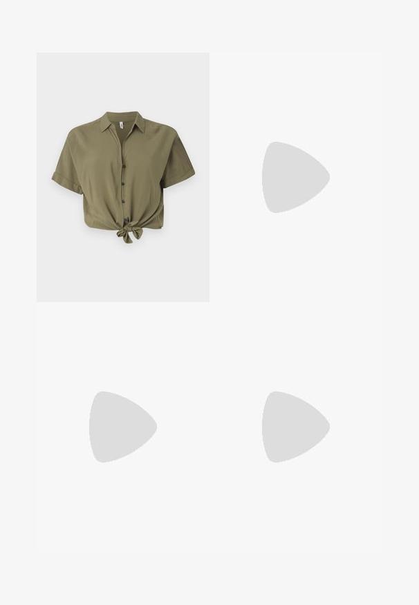 Olive green cropped button-up shirt made of soft fabric, featuring short sleeves, a tie-front detail, and black buttons.; Light blue flared jeans made of denim with a wide belt loop and a large, square silver buckle. Faded texture near the hem enhances design.; White high-top canvas sneaker with black rubber sole, front rubber toe cap, and six eyelets for laces, featuring a clean, minimalist design.; Olive green corduroy handbag with two front pockets, gold hardware, and a short strap. Worn with a light green striped sweater.