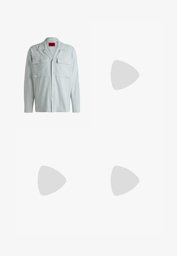 Light blue striped shirt with long sleeves, two chest pockets, and a buttoned front. Features a classic collar and soft fabric texture.; White cotton t-shirt with short sleeves and a crew neck. Centered text reads "WELCOME TO PARADISE" in a curved green font.; Beige straight-leg chinos with belt loops, front button and zipper closure, and slant front pockets.; Gray and white athletic shoe featuring a mesh upper, suede accents, three black stripes, and a textured rubber sole with round cutouts.