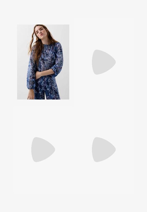 Long-sleeve blue and purple patterned blouse with a gathered neckline and elastic cuffs, featuring a soft, textured fabric.; Black polyester culotte pants with an elastic waistband, two front pleats, and a loose silhouette. No visible patterns or hardware details.; Black patent heeled sandals with a square toe, ankle straps, and silver buckles. Features a chunky block heel for stability.; Black leather handbag with a curved shape, detachable strap, and gold hardware. The bag features a flap with a buckle detail.