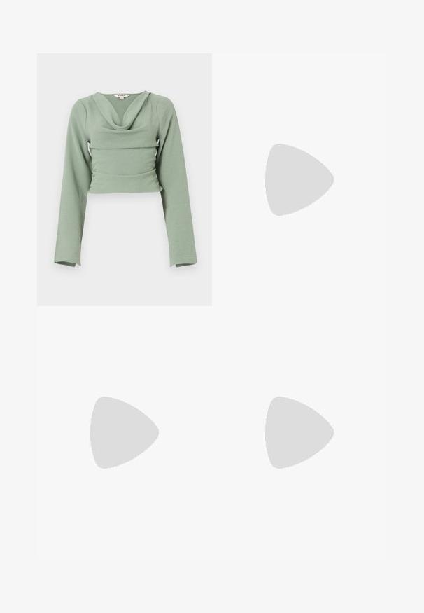 Cropped long-sleeve top in soft, textured mint green fabric. Features a draped cowl neckline and fitted design, with a horizontal seam detail.; Sister Jane HEART TO HEART - Straight leg jeans - blue denim; White high-top canvas sneaker with black rubber sole, front rubber toe cap, and six eyelets for laces, featuring a clean, minimalist design.; Red leather handbag with an angular, geometric design. Features a single adjustable strap and a flap closure with stitched detailing.