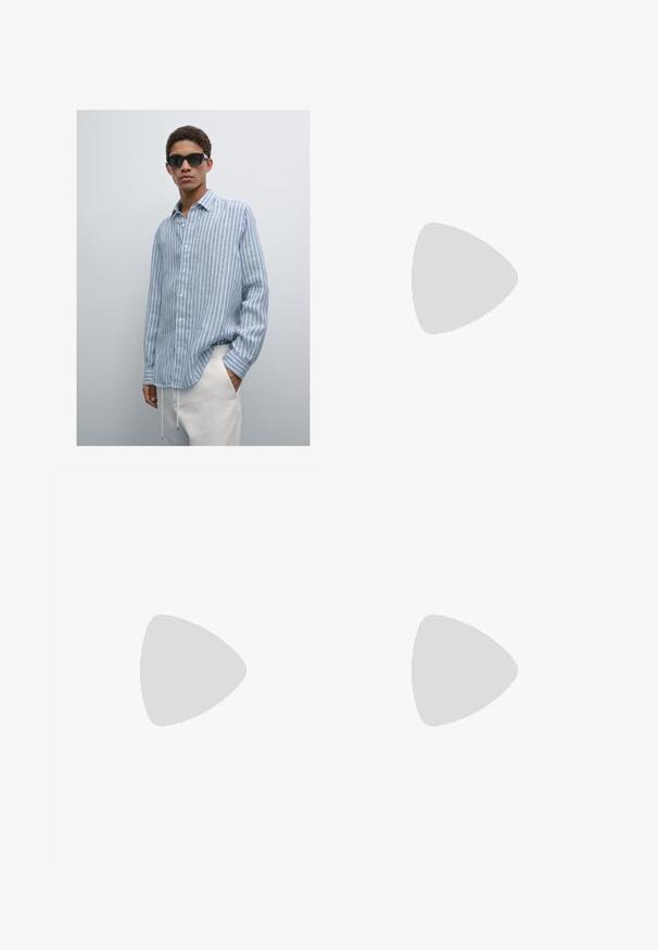 Camicia a righe blu chiaro in tessuto leggero, con bottoni, colletto e maniche lunghe, indossata con pantaloni color crema. Occhiali da sole neri.; T-shirt in cotone nero con maniche corte, scollatura rotonda e stampa in bianco e oro sulla parte sinistra del petto, caratterizzata da una vestibilità rilassata.; Jeans in denim azzurro chiaro con vestibilità rilassata, design a gamba dritta, cuciture visibili, due tasche frontali e chiusura con bottone.; Scarpa da corsa navy con tomaia in rete texturizzata, intersuola bianca e suola esterna marrone chiaro. Presenta un design minimale e un dettaglio del logo discreto.