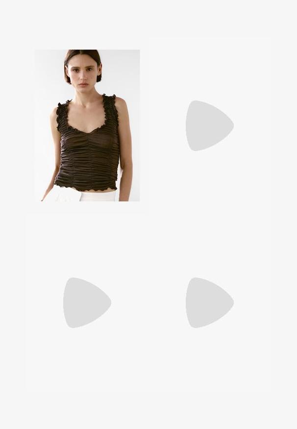 Brown ruched tank top with scalloped edges and ruffled straps, featuring a fitted design and soft texture, worn over white bottoms.; White denim skirt with a fitted design, featuring a button closure, belt loops, and classic five-pocket style. Smooth texture and knee-length.; Knee-high suede boots in camel color with a pointed toe and a thin high heel. Smooth texture and sleek silhouette with minimal detailing.; Dark brown leather handbag with a braided tassel, gold-tone hardware, double handles, and a detachable shoulder strap on a white background.