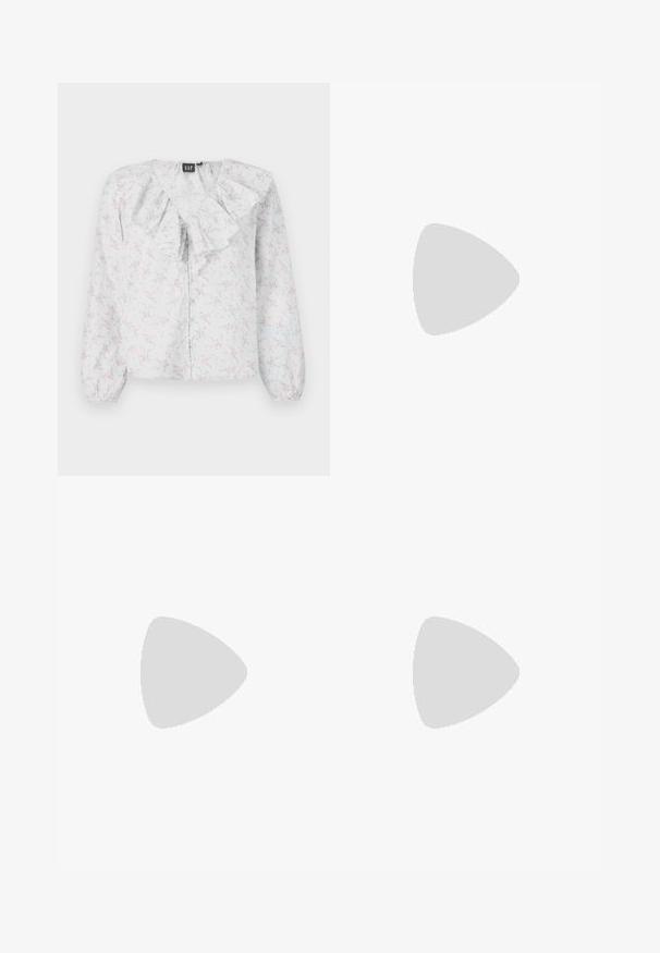 White blouse with a ruffled neckline, floral pattern in pink and blue, long sleeves, and button front closure. Lightweight, textured fabric.; Light blue denim wide-leg jeans feature a high waist, five pockets, subtle fading, and stitching accents along the seams.; White sneakers with black stripes and beige suede accents. Feature a textured gum sole and flat white laces, worn with light-colored socks.; Black leather handbag with a curved shape, detachable strap, and gold hardware. The bag features a flap with a buckle detail.