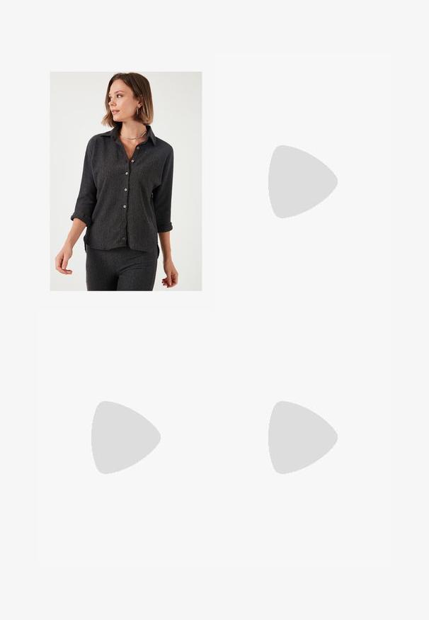 Zwarte textuur knoopshirt met lange mouwen opgerold tot de ellebogen, met houten knopen en een klassieke kraagontwerp.; Bruine wijde broek gemaakt van zachte stof, met een elastische tailleband en een trekkoord, en twee zijzakken.; Bruine suède sneaker met witte leren strepen, rubberen zool, ronde neus en vetersluiting. Kenmerkt zich door een logo op de tong en geperforeerde accenten.; Bruine leren tote bag met een gladde textuur, een ontwerp met een open bovenkant en twee schouderbanden. Kenmerkt zich door minimale stiksels en geen zichtbare hardware.